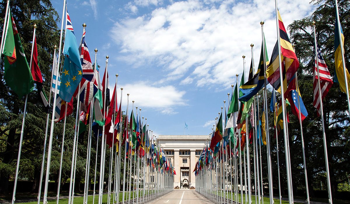 United Nations building in Geneva surrounded by flags from various countries